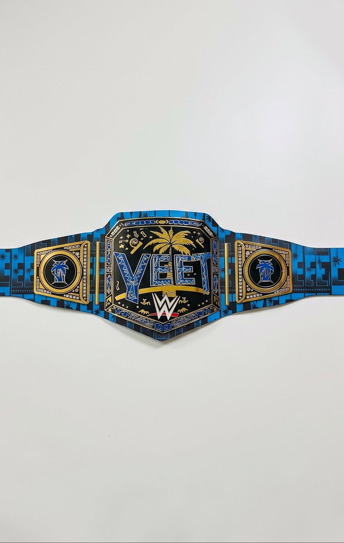 A blue and black patterned WWE MVP championship belt with gold accents, displayed horizontally against a plain light gray background.