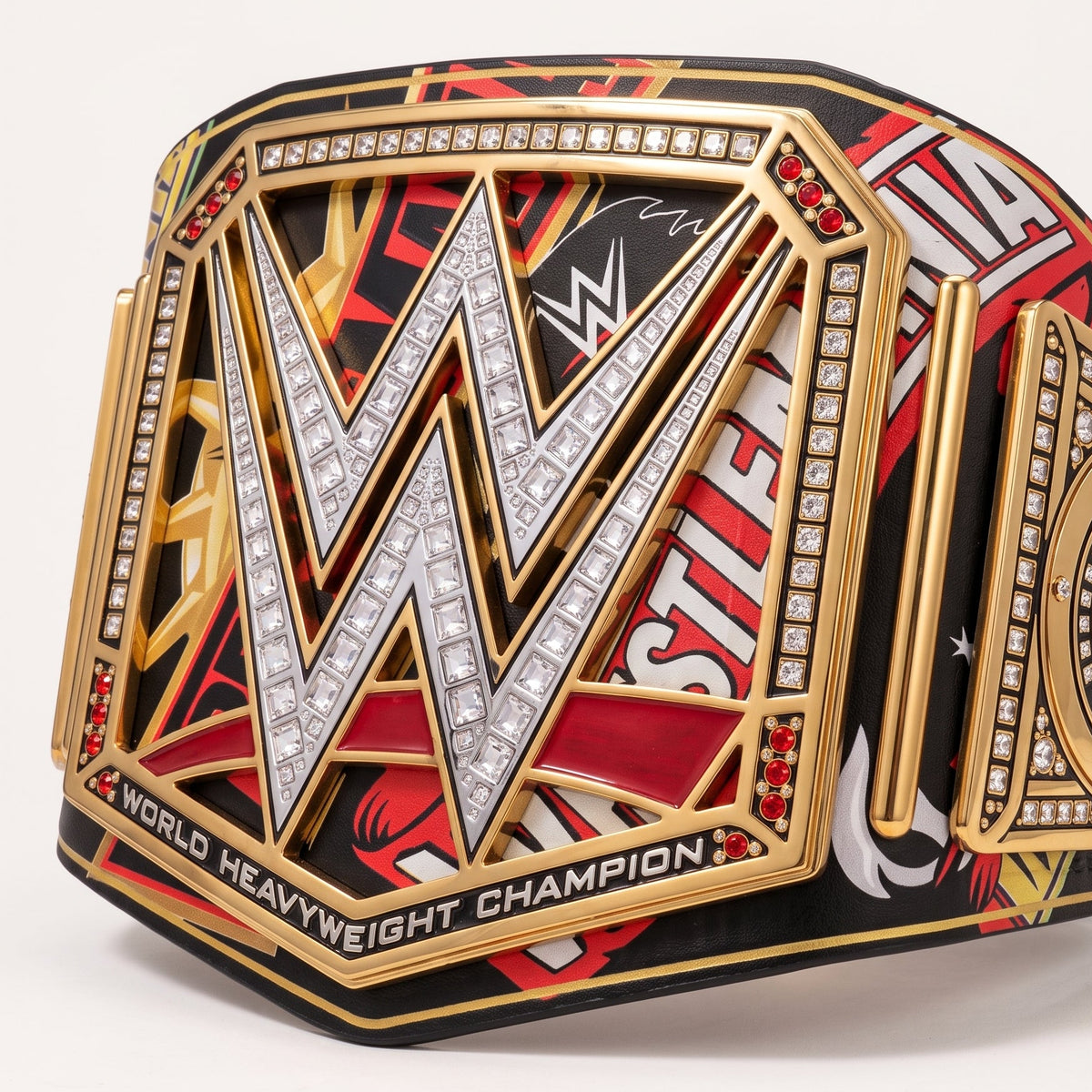 A WWE World Heavyweight Championship belt featuring a large gold-plated central plaque with a silver crystal-embellished 'W' logo, red and black graphic panels, and a side plate with a gold circular WWE emblem.