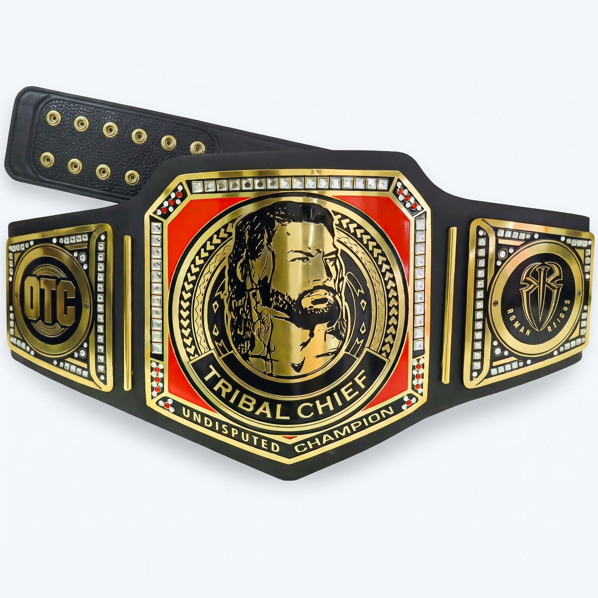 A championship belt with a black leather strap, gold-plated metal plates, and a red center panel featuring a gold tribal chief portrait. The belt includes the text 'TRIBEAL CHIEF' and 'UNDISPUTED CHAMPION,' with 'OTC' on one side plate.