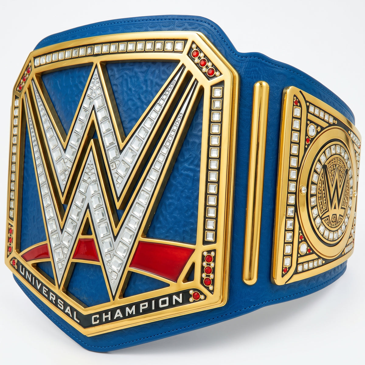 A blue and gold WWE Universal Champion belt with a large silver 'W' outlined in gold, accented with red and white crystal details, shown on a clean white background.