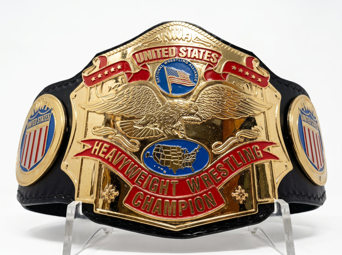 A replica United States Heavyweight Wrestling Championship belt with a large gold-plated eagle and scrollwork centerpiece, red banners, blue state-of-union emblems, and a black strap, displayed on clear acrylic stands against a white background.