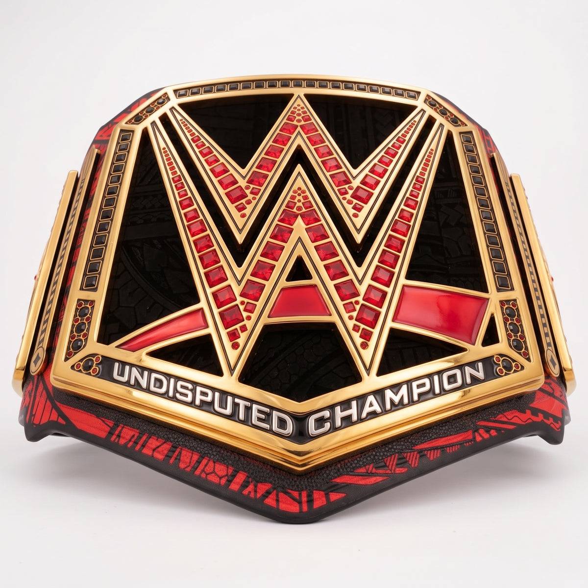 WWE Undisputed Champion belt featuring a large gold 'W' emblem with red and black mosaic detailing, and 'UNDISPUTED CHAMPION' text on a clean white background.