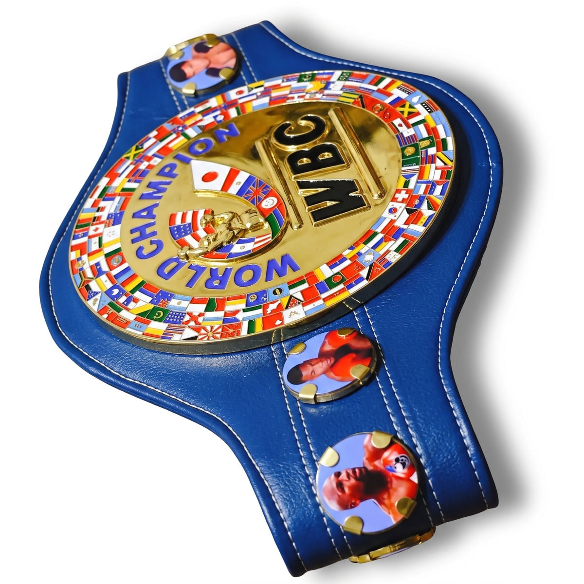 A blue and gold World Boxing Championship belt featuring a large central gold medallion with 'WBC' and 'WORLD CHAMPION' text, surrounded by many national flags. Two side medallions show boxer portraits, including Floyd Mayweather.