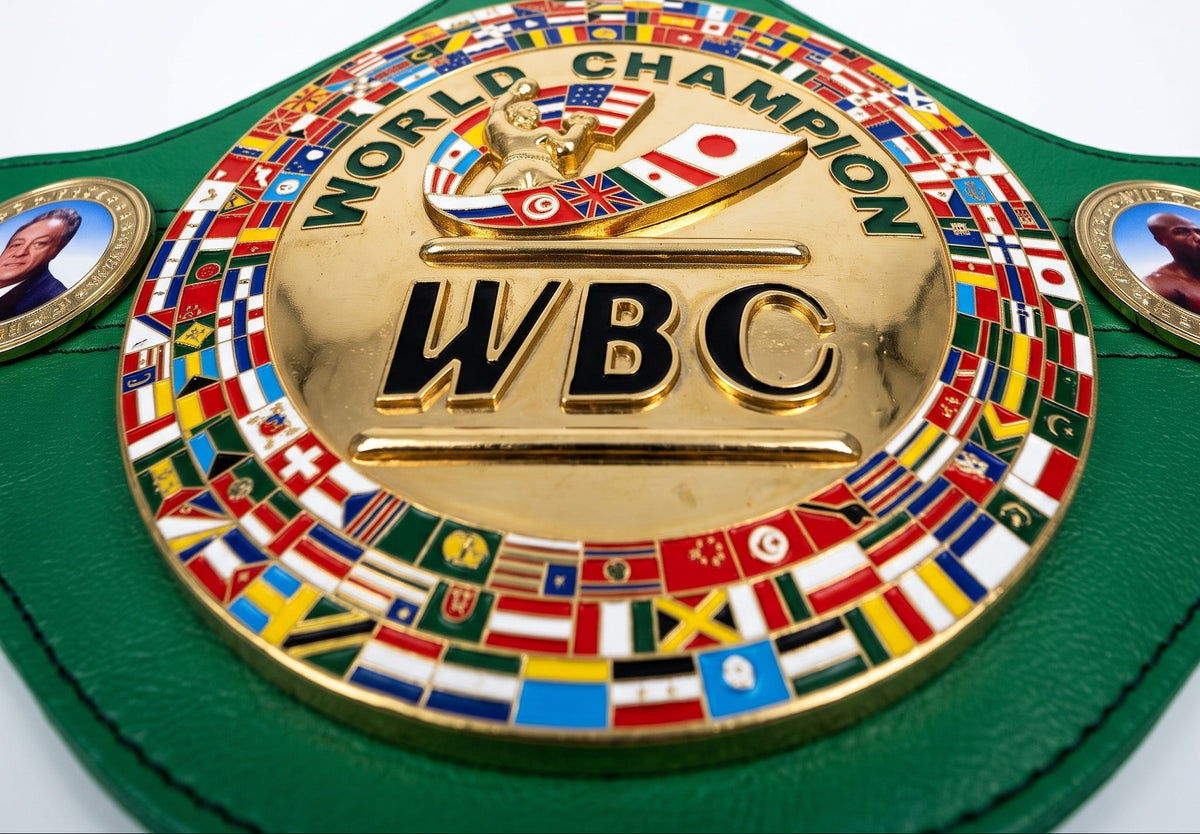 A green leather WBC World Champion belt with a large gold-toned central medallion featuring the letters 'WBC' and surrounded by many colorful national flags. The belt is photographed on a clean white background.