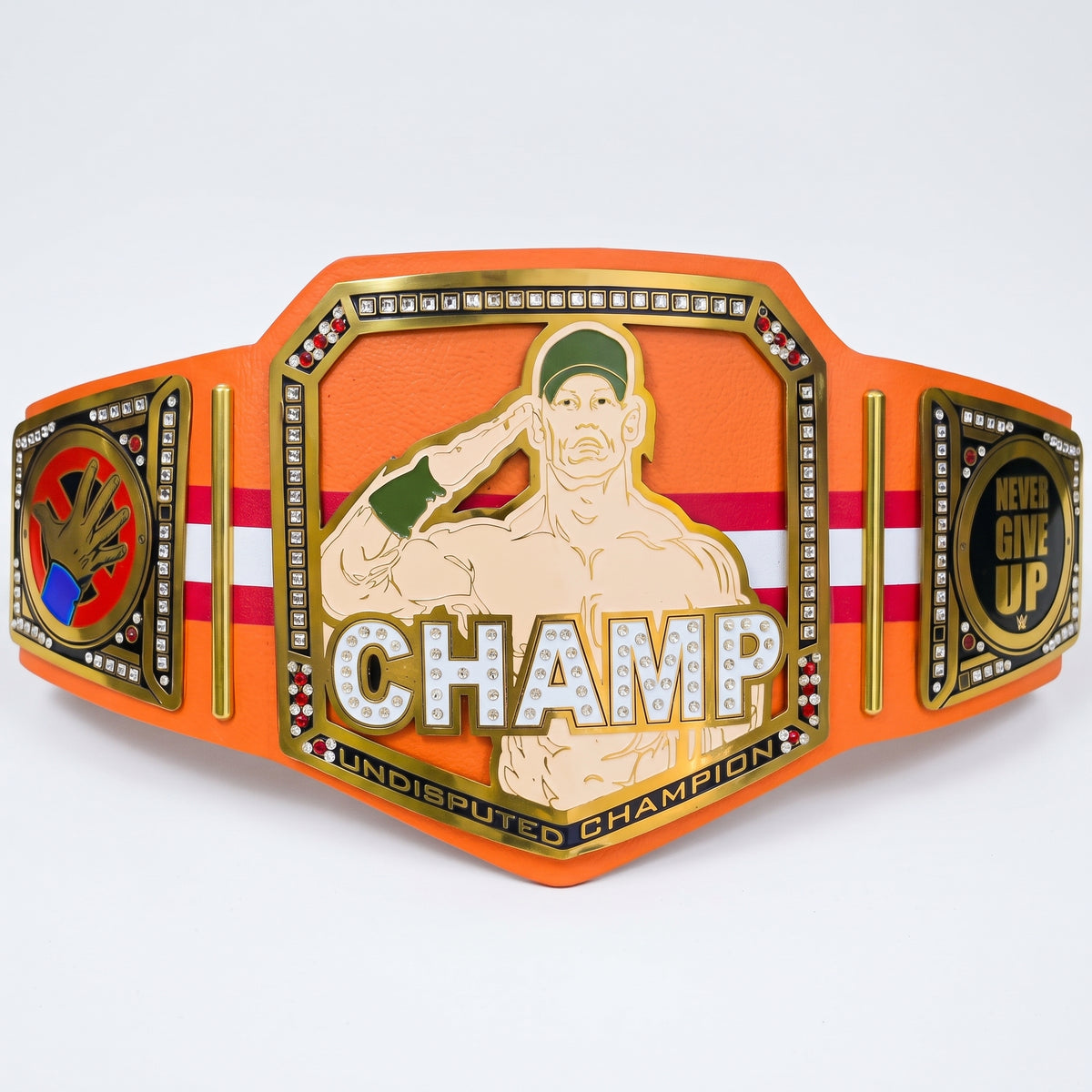 An orange and gold championship belt featuring a central plate with an illustration of a muscular man saluting and the word 'CHAMP' in large letters. The belt includes side plates with additional decorative emblems and text, photographed on a clean white background.