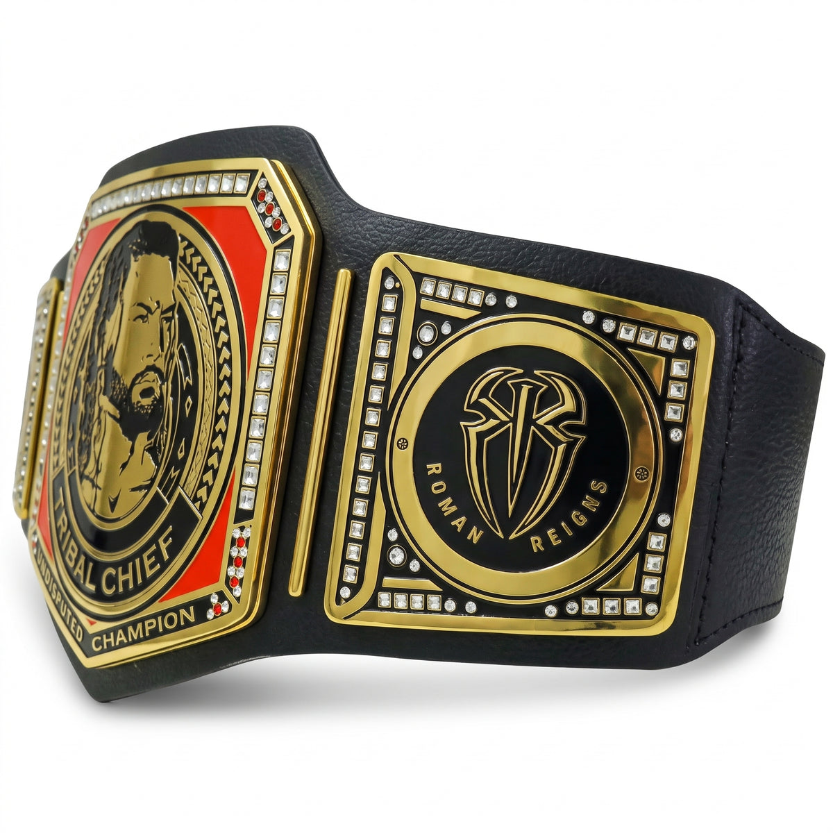 A black faux-leather championship belt with ornate gold-tone metal plates, red and white accents, and rhinestone details. The left plate shows a portrait with the text 'ROYAL CHIEF CHAMPION,' and the right plate displays a shield emblem reading 'ROMAN REIGNS.