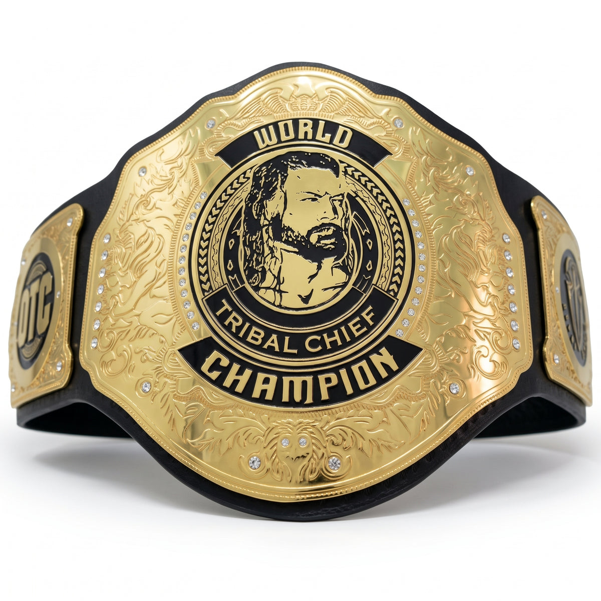 A custom championship belt featuring a large gold-toned central plate with black engraved text reading 'WORLD TRIBAL CHIEF CHAMPION' and a portrait, mounted on a black strap with small rhinestone accents.
