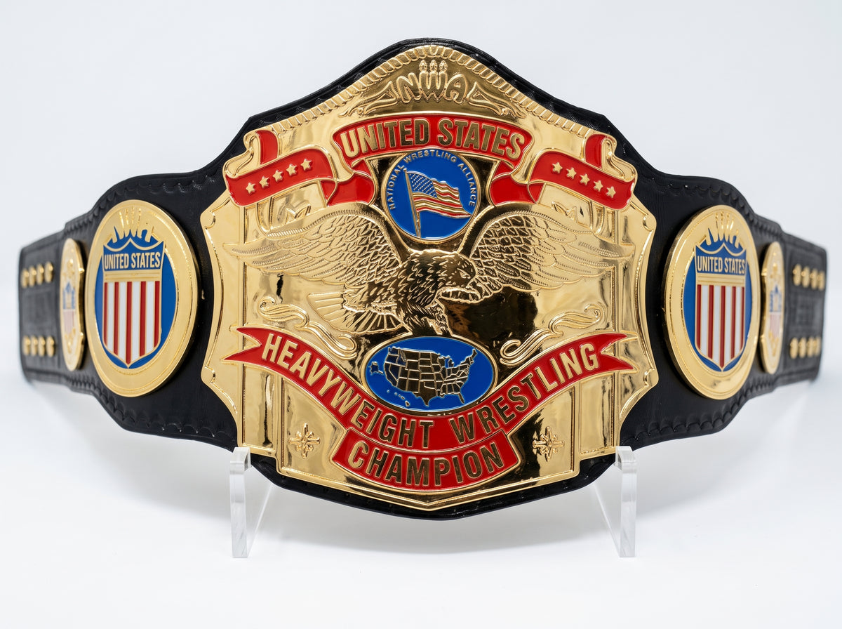 A replica United States Heavyweight Wrestling Championship belt with a large gold-plated central plate featuring an eagle and red and blue enamel details, flanked by two smaller gold and blue plates on a black strap, displayed on clear stands against a white background.