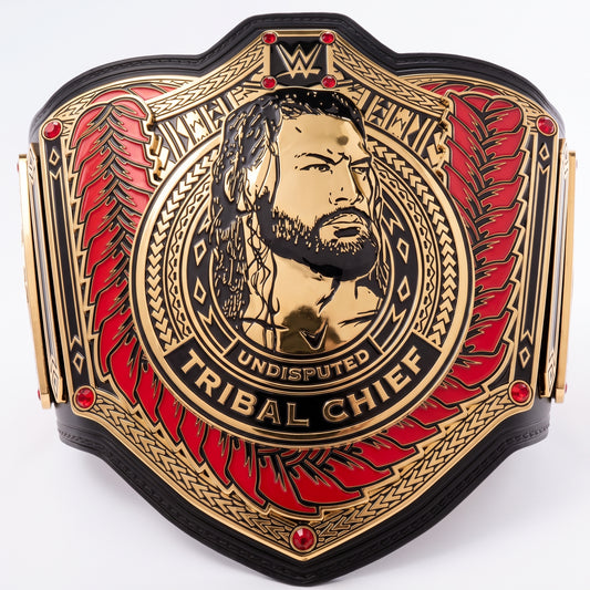 A WWE Undisputed Tribal Chief championship belt featuring a gold-toned central portrait of Chief, red feather-like wing panels, and black leather-like borders on a plain white background.