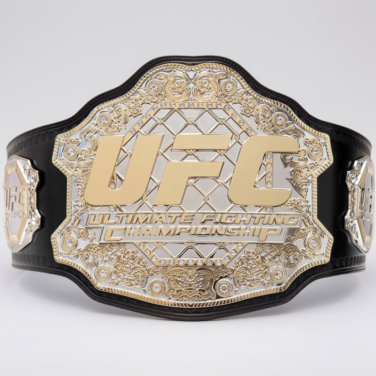A black and gold UFC Ultimate Fighting Championship belt shown against a light gray background.
