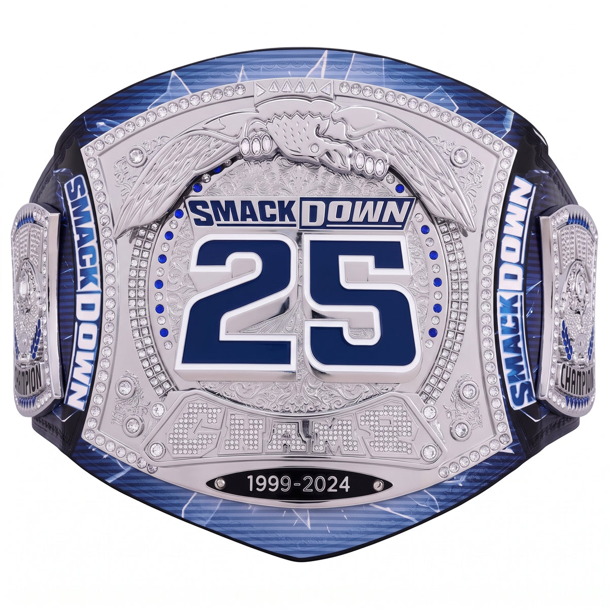 A commemorative championship belt featuring a large silver-toned central plate with blue and silver details, the number 25, and 'SMACKDOWN 1999-2024' text, shown on a plain white background.