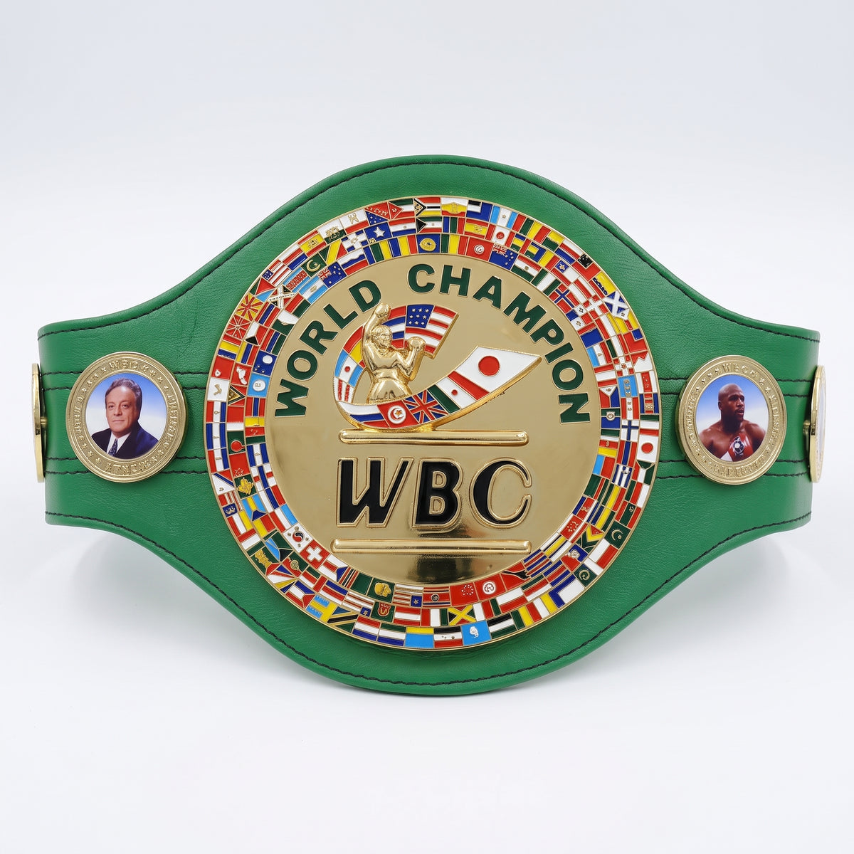 A green and gold boxing championship belt featuring a large central gold plate with 'WORLD CHAMPION WBC' and a boxer graphic, surrounded by many small national flags. Two side medallions show portraits of boxers on a white studio background.