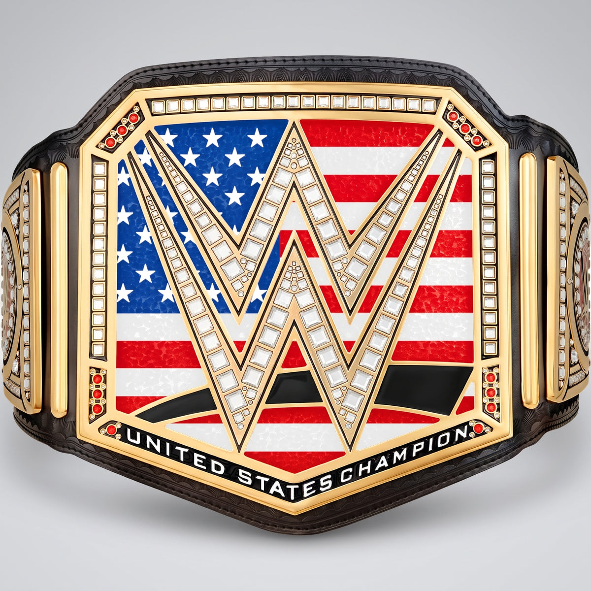WWE United States Championship belt featuring a gold-plated frame, a central American flag design with a large gold 'W' outlined in rhinestones, and 'UNITED STATES CHAMPION' engraved along the bottom, shown on a light gray background.